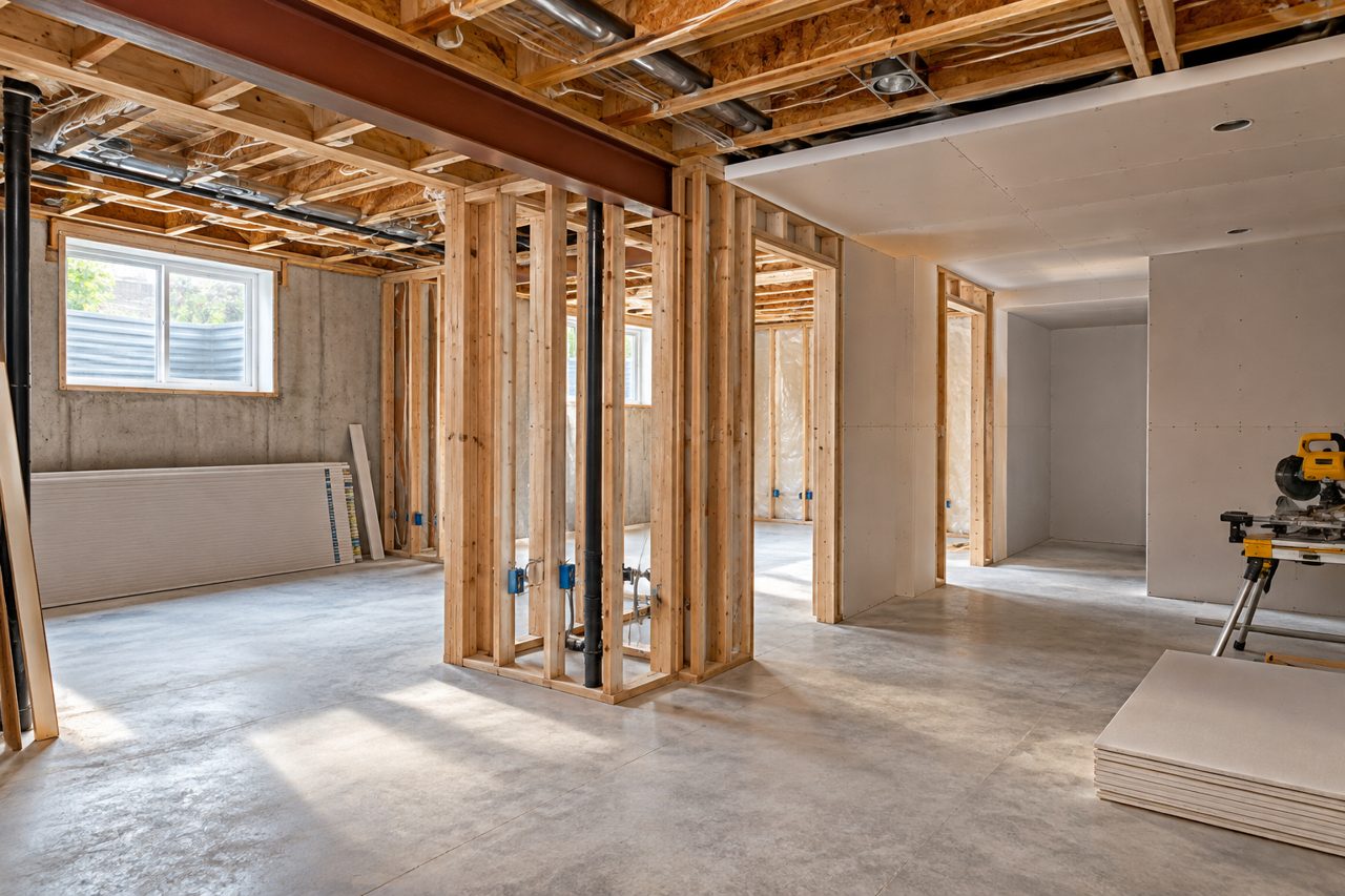 Unfinished basement being framed for renovation
